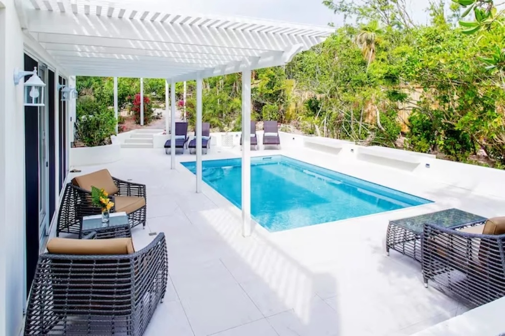 Vacation rental exterior with pool and outdoor seating
